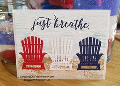 a card that says just breathe with two lawn chairs in front of the water and sand