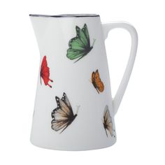 a white pitcher with butterflies painted on it