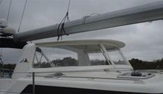 a white and black boat in the water on a cloudy day with no one around it