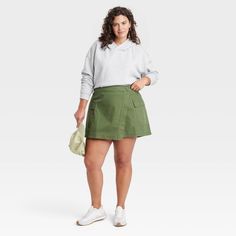 Elevate your collection of bottoms for casual occasions with this Wrap Miniskirt from Universal Thread™. Crafted from midweight cotton fabric in a regular fit, this wrap miniskirt offers a perfect balance of comfort and style. It's designed with a side button closure for a snug fit, while the flap and cargo pockets provide space for small essentials. Pair it with just about any top in your closet for a number of versatile looks. Universal Thread™: Found exclusively at Target. Casual Green Cotton Cargo Skirt, Fall Cotton Mini Cargo Skirt, Cotton Mini Cargo Skirt For Fall, Spring Cotton Cargo Skirt, Fall Cotton Cargo Skirt With Relaxed Fit, Casual Cotton Cargo Skirt For Spring, Casual Fall Cotton Cargo Skirt, Casual Cotton Cargo Skirt For Fall, Green Cotton Mini Skirt For Fall