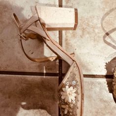 a pair of shoes sitting on top of a tiled floor