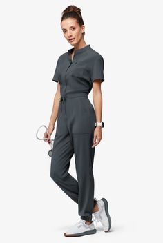 Now, this is modern. A jumpsuit! No easier way to get dressed – nothing to match and your top stays tucked in. Ours is so cute – a drawstring to add shape plus six functional pockets. The Easy Stretch Collection is designed for a modern look and easy fit. 4-way stretch performance fabric keeps you comfortable all shift long.. Easy Stretch Allie Women's 6-Pocket Short Sleeve Jumpsuit - Size M Scrub Style, Short Sleeve Jumpsuit, Mens Scrubs, Scrub Jackets, Easy Stretches, Medical Uniforms, Short Sleeve Jumpsuits, Family Print, Jumpsuit With Sleeves