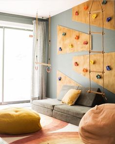 a living room filled with furniture and climbing wall