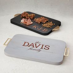 two trays with food on them sitting next to each other in front of a sign that says, the davis family