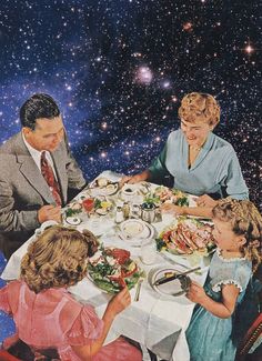 a family sitting around a dinner table in front of the stars