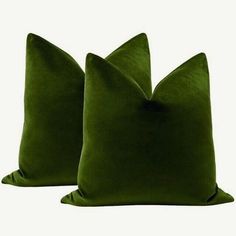 two green velvet pillows on white background