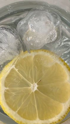 lemon slices and ice cubes in a glass bowl