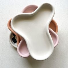 three bowls are stacked on top of each other in the shape of an animal's head