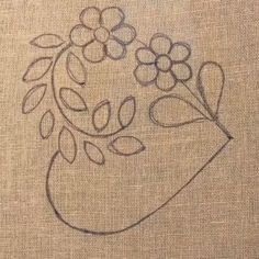 a drawing of a vase filled with flowers on top of a piece of linen fabric