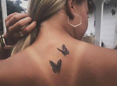 a woman with a butterfly tattoo on her back