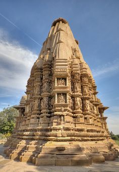 an intricately carved stone structure in the middle of a park