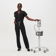 Official FIGS® Scrubs. Ridiculously Soft Scrubs Designed Just For You. Get Free Shipping On Orders $50+! | FIGS Womens Black Catarina™ ScrubJumpsuit™ Black Figs, Vest Layering, Nursing Scrubs, Black Fig, Scrubs Outfit, Black Scrubs, Figs Scrubs, Easy Dress, Trouser Pocket