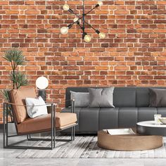 a living room filled with furniture and a brick wall behind the couches is a round coffee table