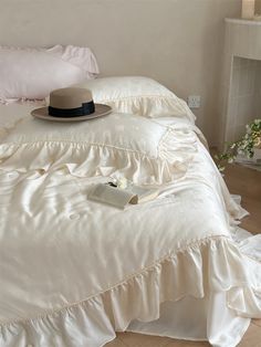 a white bed with a hat on top of it