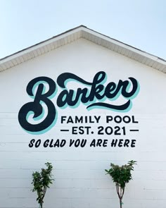 a sign on the side of a building that says baker family pool - est 2091 so glad you are here