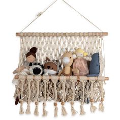 a hammock filled with stuffed animals on top of a white wall mounted shelf