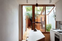 a kitchen with an island in front of a window and a sink next to it