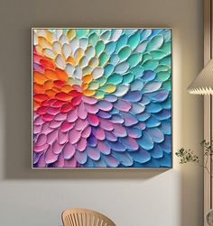 a colorful painting hanging on the wall above a chair