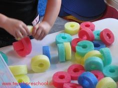 a child is playing with foam letters on a table