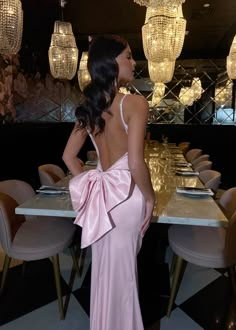 Feel like royalty in our 'Problematic Princess' Bow Gown! The stunning low plunge back and diamante trim add a touch of glamour, while the large bow detail on the back makes a statement. The soft stretch satin fabric hugs your curves, and the maxi length and fishtail silhouette give you an elegant and flattering look. Rule the night with confidence! Bow detail on back Diamante trim Stretch Satin fabric Colour: Pink Our DressMeZee model Jess is 5'6 and wears size XS 6. Nina is 5'6 and wears size Pink Dress With Bow In The Back, Prom Dress Bow Back, Dress With Bow In The Back Prom, Bow Pink Dress, Pink Bow Prom Dress, Pink Maxi Dress Formal, Prom Dress With Bow On Back, Pink Gown Elegant, Pink Bday Dress