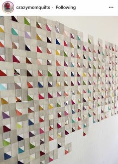 several pieces of paper are arranged on the wall with different colors and shapes in them