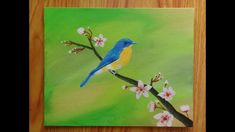 a painting of a blue bird sitting on a branch with white flowers in the foreground