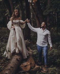 a man and woman holding hands walking through the woods in front of some trees, with text that reads instagram heyweddweddings