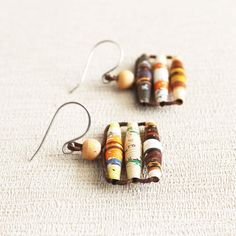 two pairs of earrings made out of crayons on white carpeted flooring