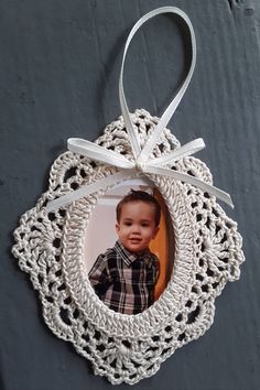 an ornament hanging from the side of a wall with a photo in it