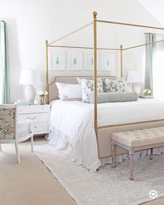 a bedroom with a white bed and blue drapes on the windowsill, two nightstands at the foot of the bed