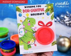 a hand holding up a christmas card with the words wishing you doh - lightful holidays