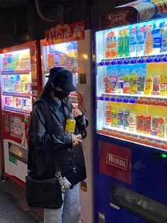 a woman standing in front of a vending machine