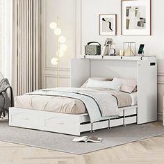 a white bed sitting in a bedroom on top of a hard wood floor