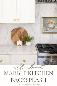 marble kitchen backsplash with white cabinets and gold knobs