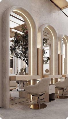 the interior of a hair salon with chairs and tables in front of large arched windows