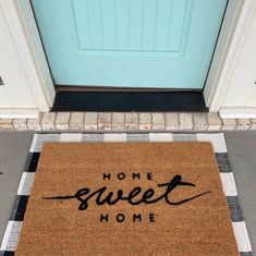 a welcome mat with the words home sweet home written on it in front of a blue door