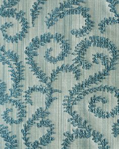 a blue and white fabric with an intricate design on the back side, in very close up