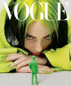 a woman with green hair and nails on the cover of a magazine that has an image of a man in neon green