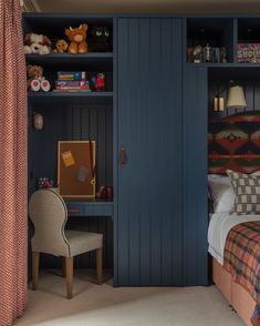 a bed room with a neatly made bed next to a blue book shelf filled with books