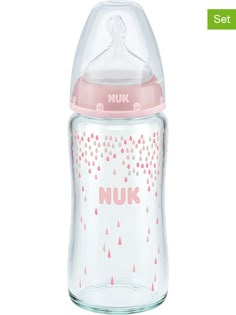 a pink and white baby bottle with the word nuk on it's side