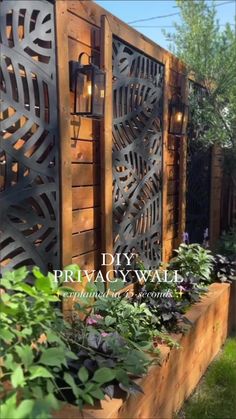 a wooden fence with plants growing in it and the words, diy privacy wall