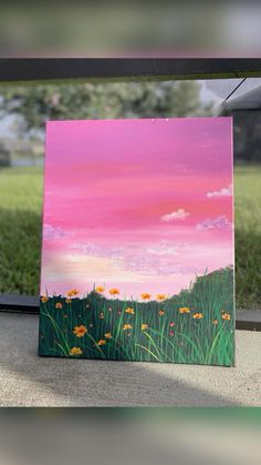 an acrylic painting of grass and flowers in front of a pink sky with clouds