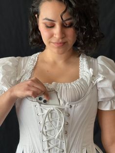 Add a front stomacher with a pocket to your Ren Faire Bodice. A handy hidden pocket to hide your phone, keys or emergency snacks! Our added stomacher is a piece that lays underneath your corset laces, covering that area, and adding an additional layer between you and the lacing area. Our Pocket Stomacher features light inner boning on one side to keep it flat and easily placed, with a phone sized pocket on the other side, closest to your body. Stomachers can be sewn in or left unattached so that Ren Faire Costume, Bodice Pattern, Steampunk Clothing, Corset Lingerie, Outfit Making, Lace Corset, Hidden Pocket, Street Outfit, Feature Light