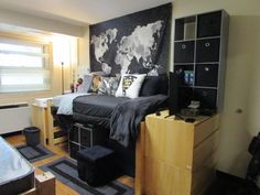 a bed room with a neatly made bed next to a desk and bookcases