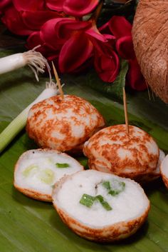 some food is sitting on a green plate with red flowers in the backgroud