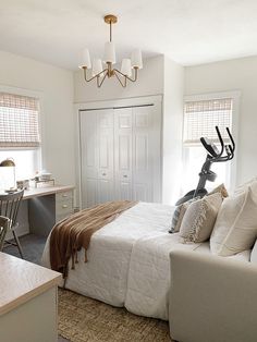 a bed room with a neatly made bed and a desk