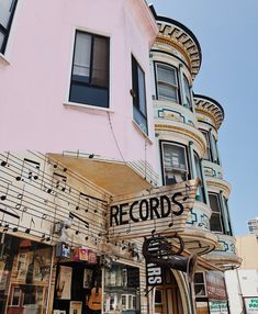 a building with musical notes on the front and side of it's sign that reads records