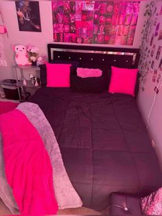 a bed room with a neatly made bed and lots of pink decorations on the walls