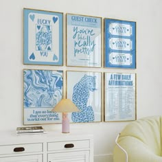 four blue and white art pieces hang on the wall above a dresser in a bedroom