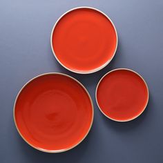 three red plates sitting next to each other on a table